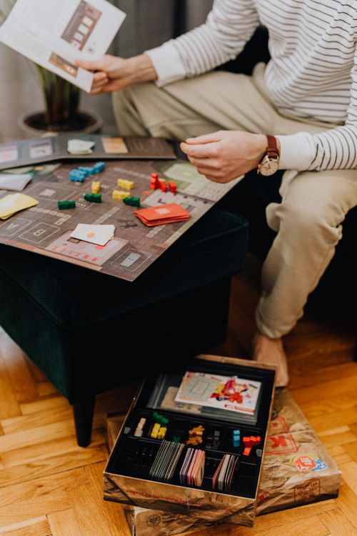 Free Casual indoor scene of a man enjoying a board game, highlighting leisure and strategy. Stock Photo