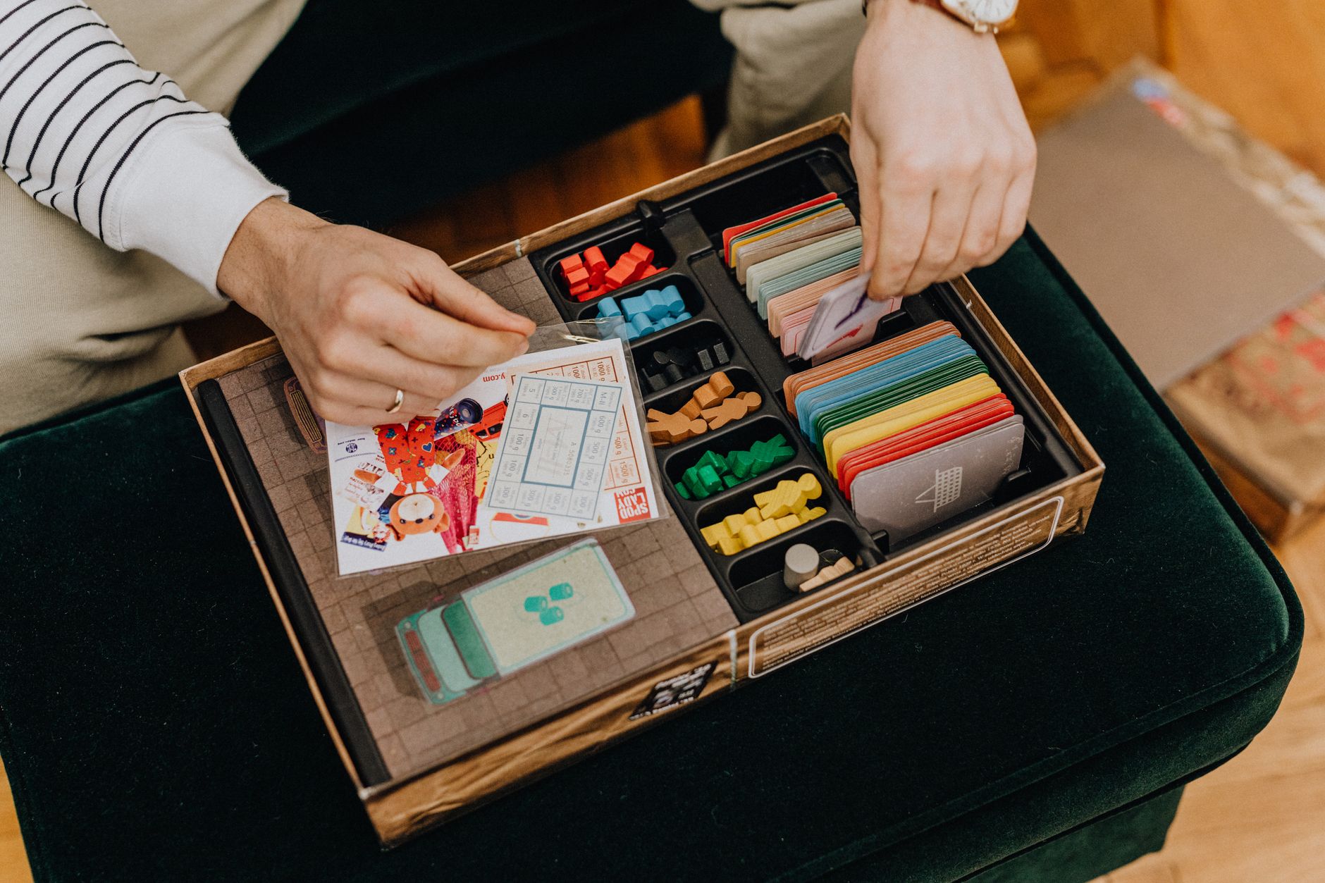 Close-up of a board game setup being organized for a fun leisure activity.