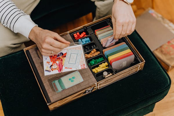 Hands placing train pieces