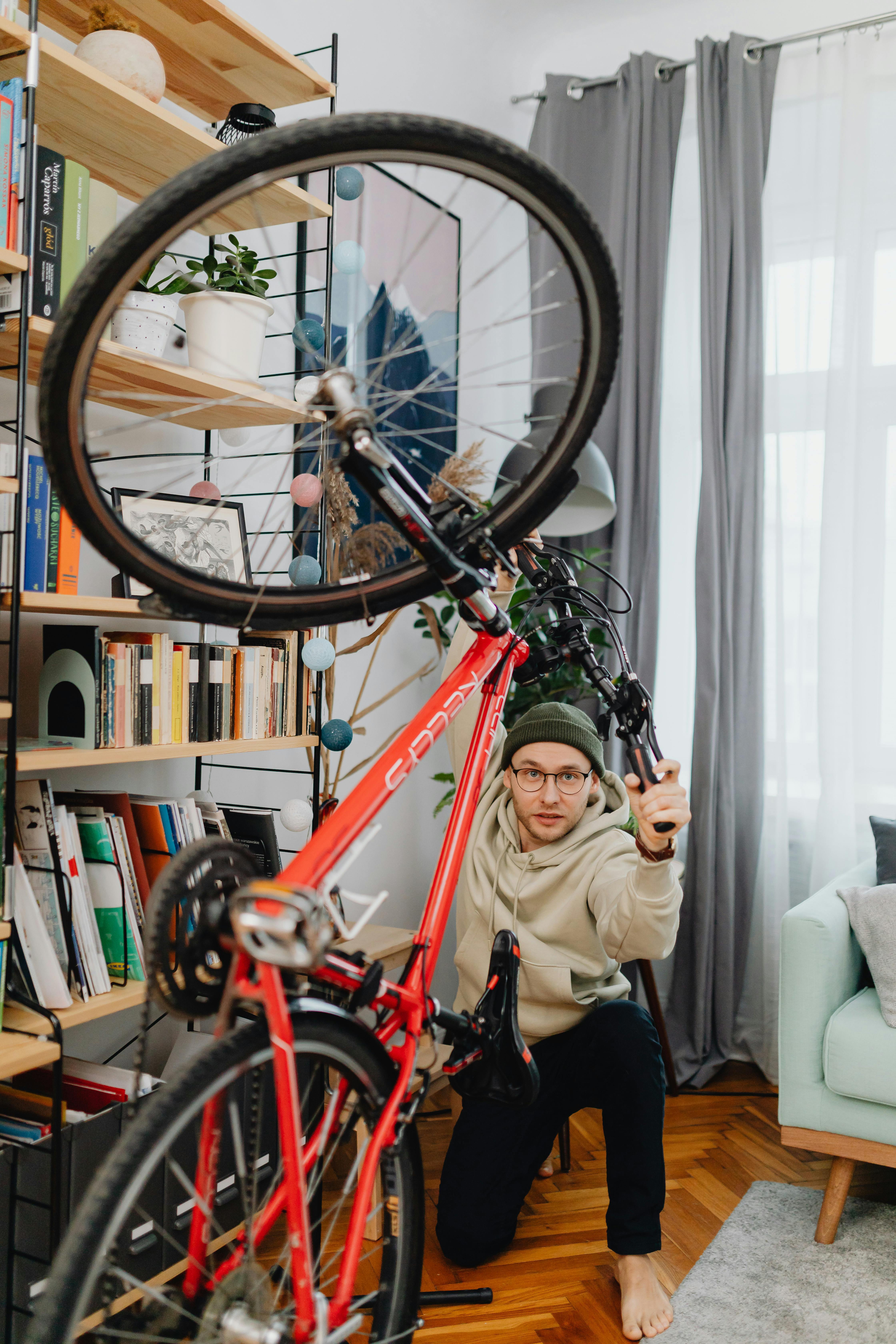 A man in a knit hat gets ready for a bike ride in his stylish apartment.