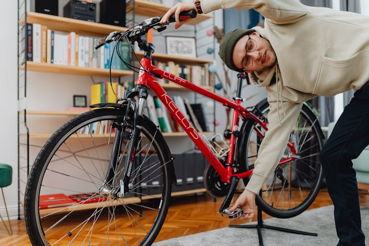 Man Fixing Bicycle At Home 