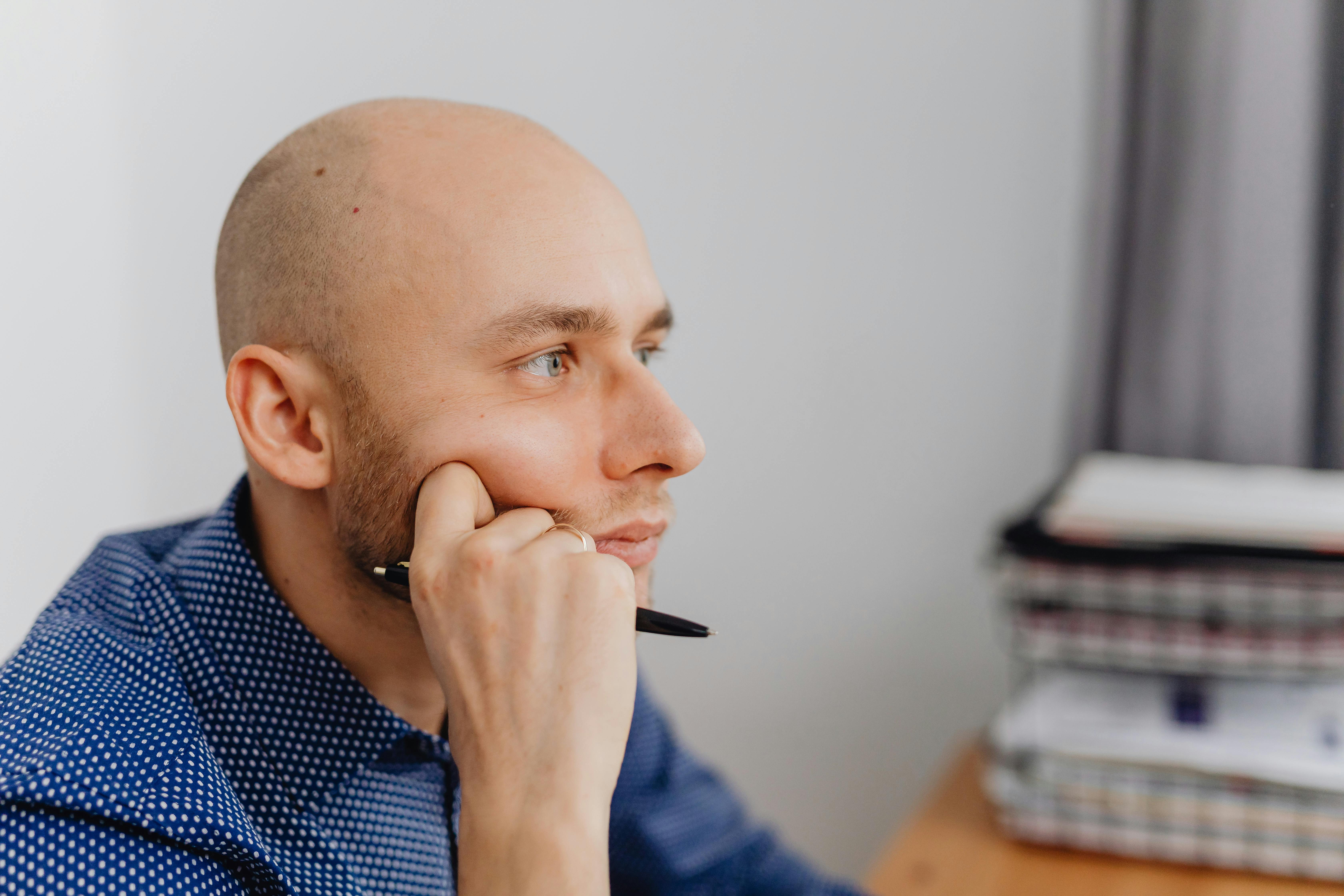 man sitting and thinking in office