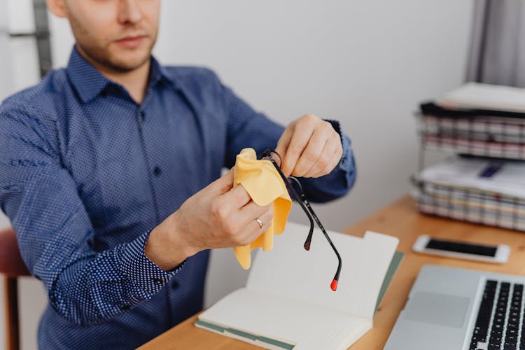 Man Cleaning Eyeglasses