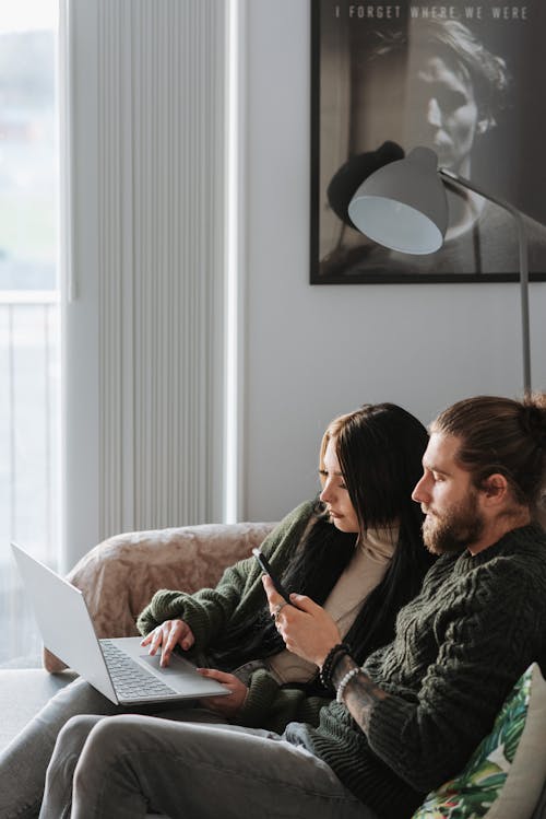 Man and Woman Sitting on Couch