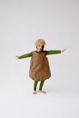 A Girl in Acorn Costume Posing with Arms Raised on Both Sides