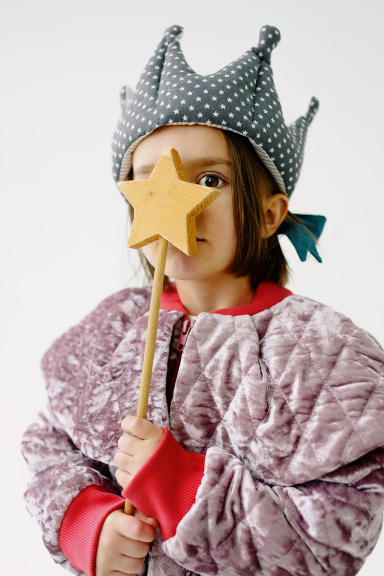 Girl Wearing Crown And Holding Wooden Star