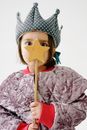 Person in Purple and White Floral Robe Holding Brown Wooden Stick