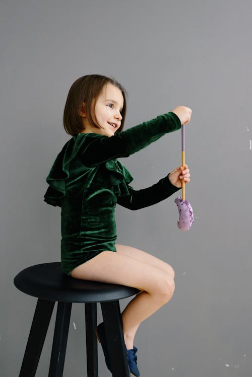 Side View of a Girl Sitting Wearing Green Leotard