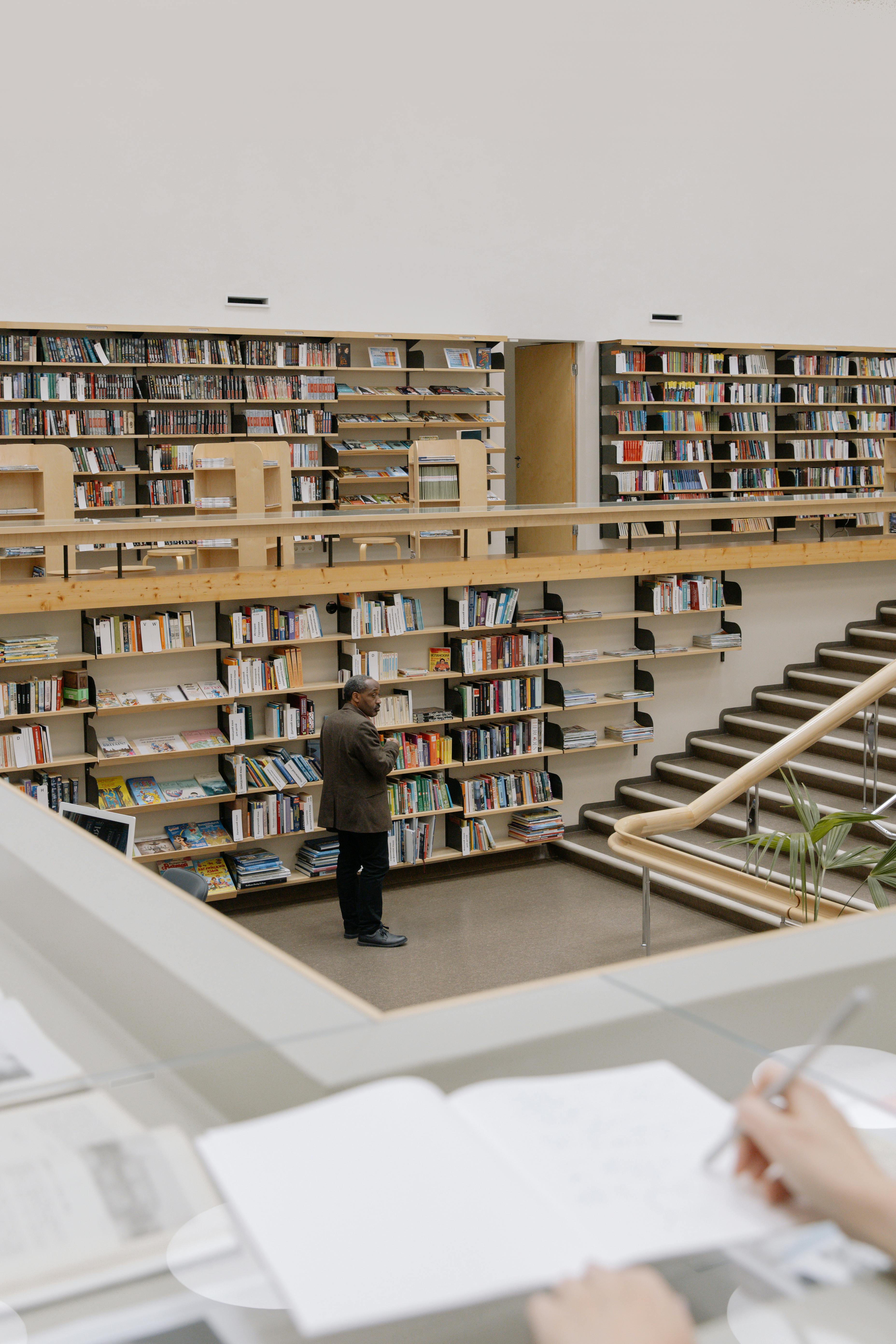 man standing inside a public library