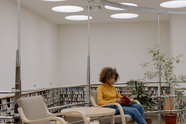 Woman In Yellow Long Sleeve Shirt Sitting On White Plastic Chair