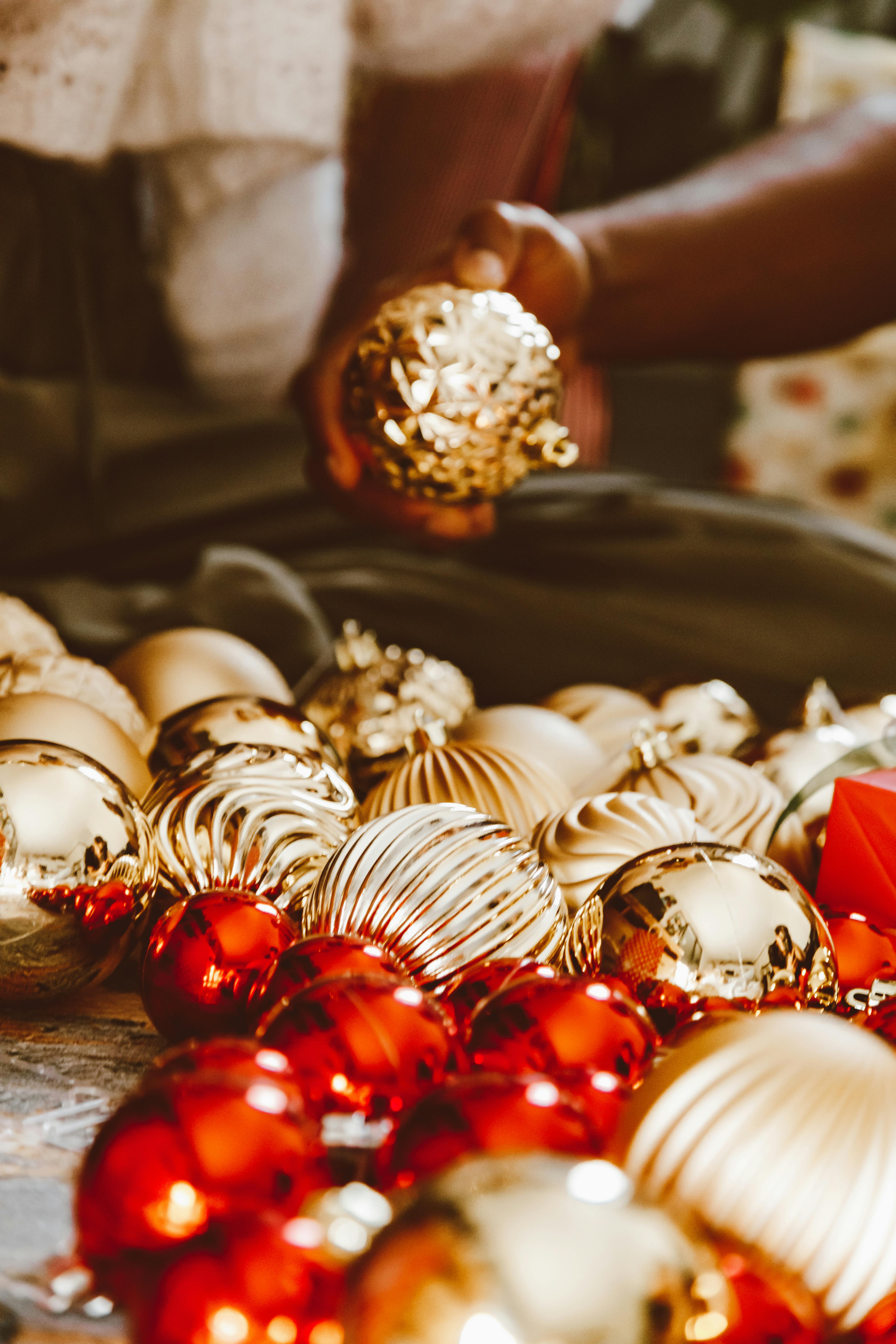 a person holding a christmas ball