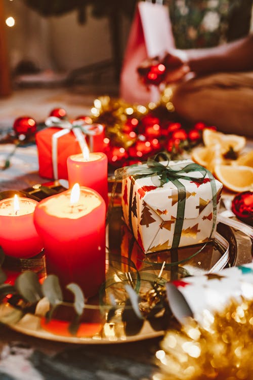 Free Lighted Candles Besides a Gift Stock Photo