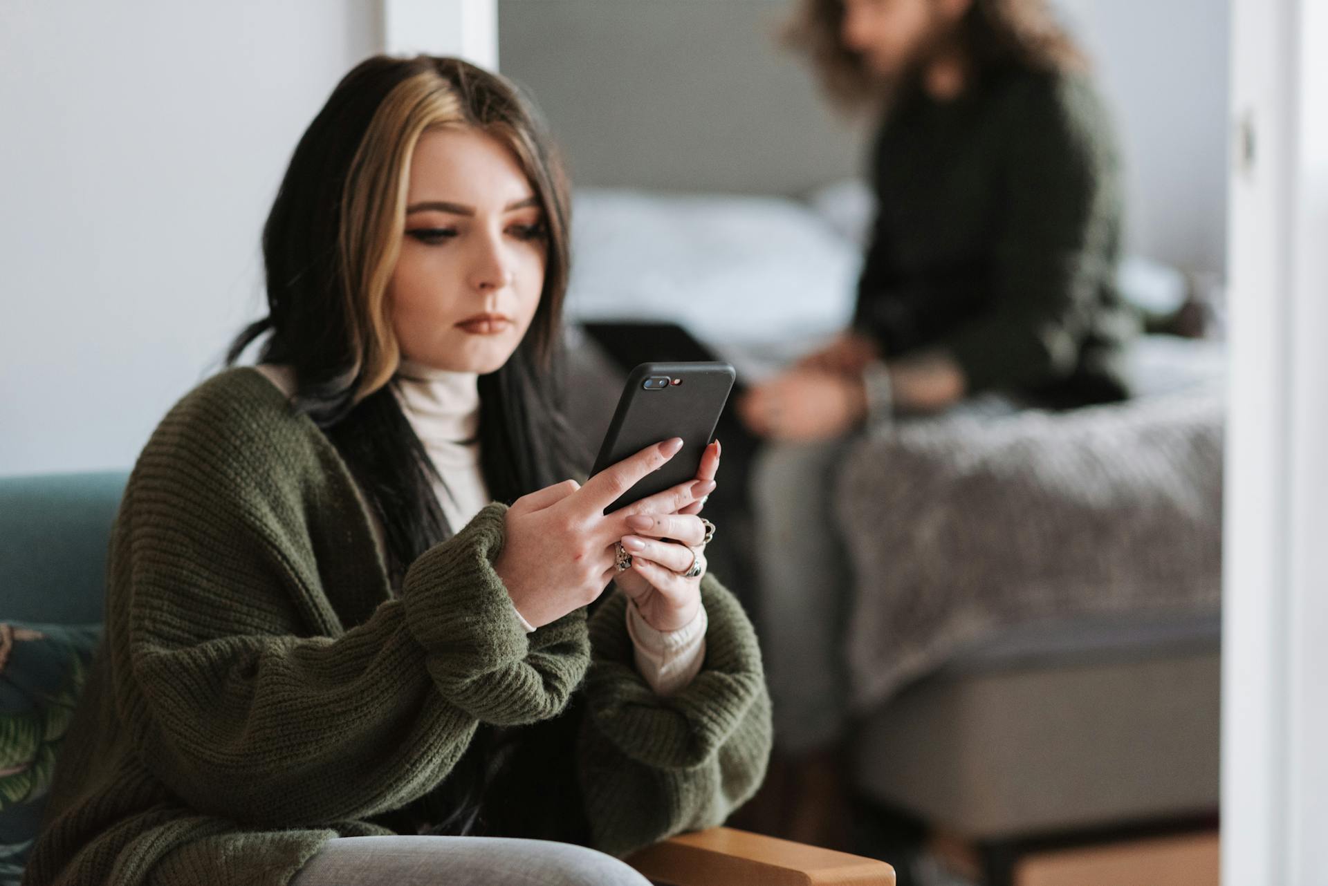 A young couple focused on their smartphones, highlighting modern communication and relationship dynamics.