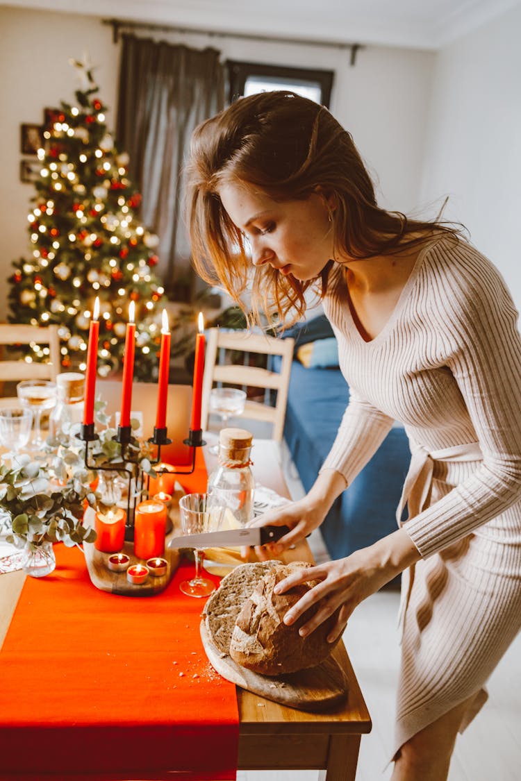 A Woman Slicing A Bread