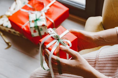 Free A Person Holding a Christmas Presents Stock Photo