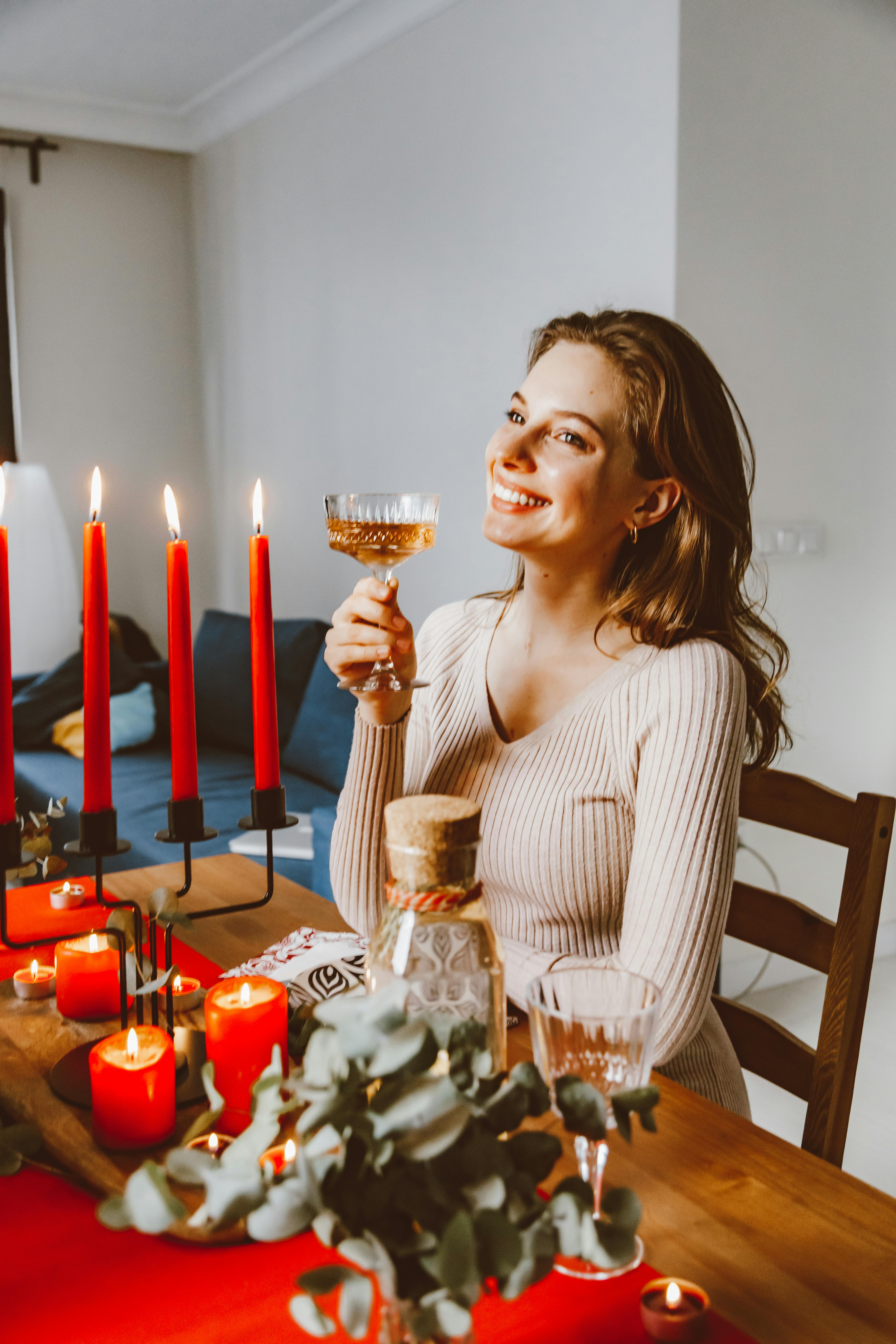 A Woman Holding a Glass of Champagne · Free Stock Photo