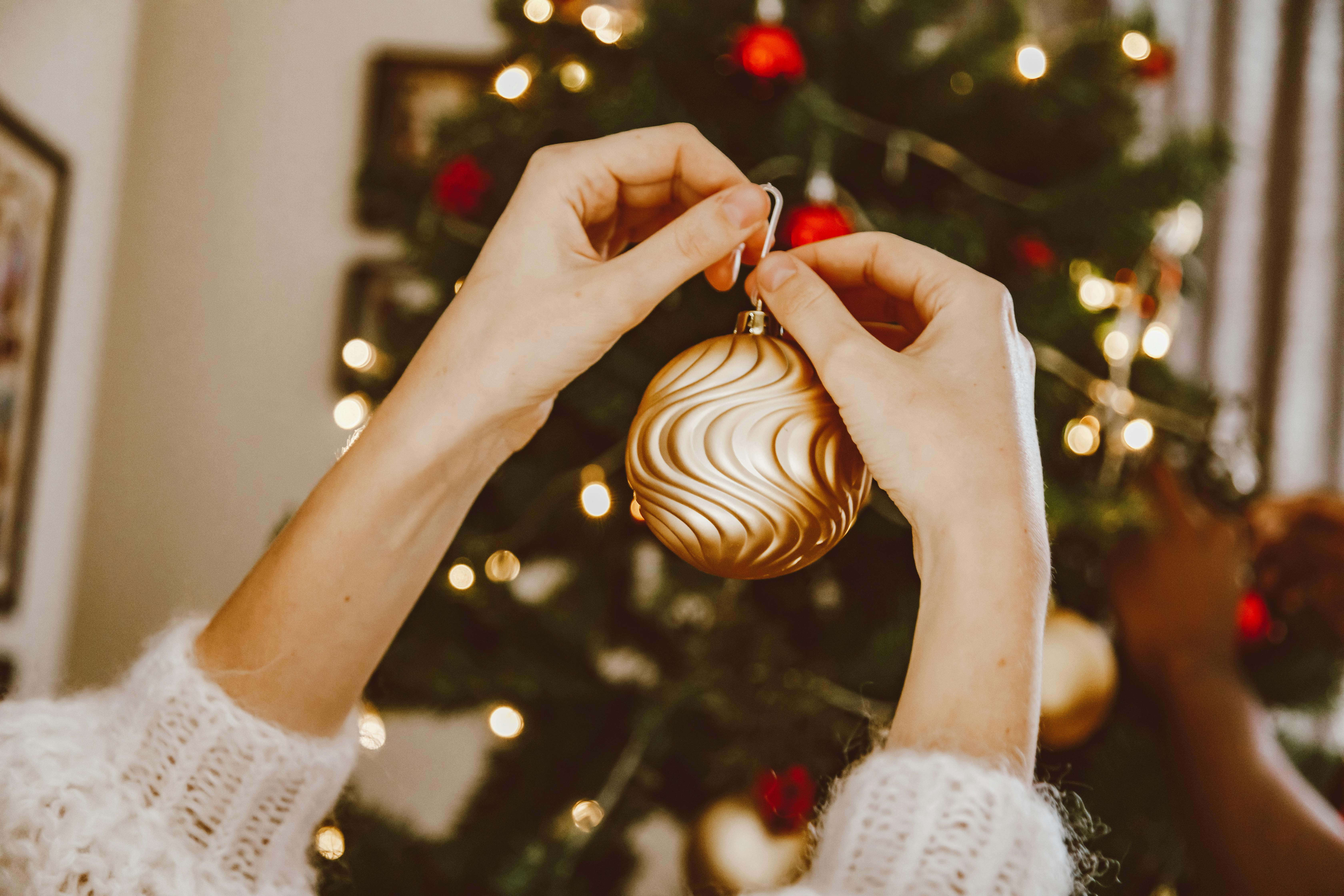 a person holding a gold bauble