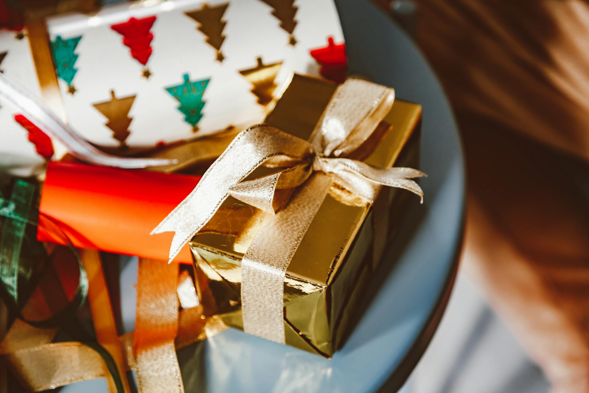 Close-up of beautifully wrapped Christmas gifts with festive paper and ribbon, perfect for the holiday season.