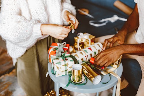 A Man and a Woman Wrapping Christmas Presents