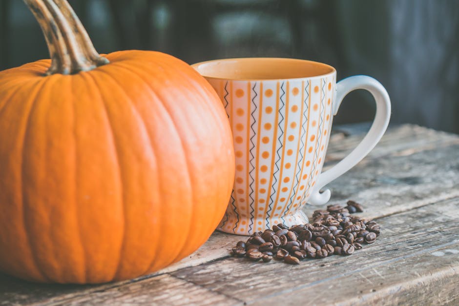 Orange Pumpkin Near White Ceramic Mug With Seeds