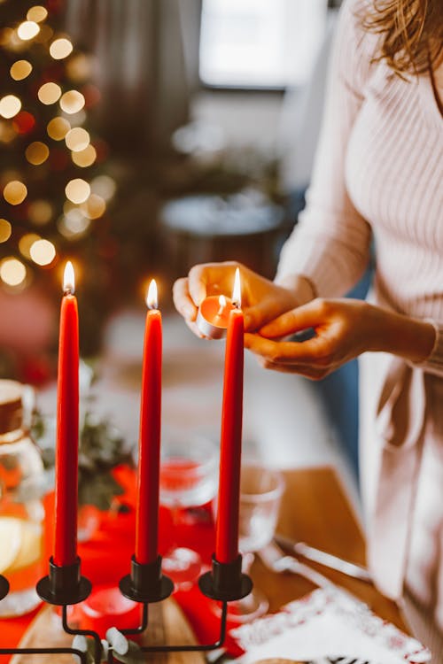 Free Person Lighting Red Candles Stock Photo