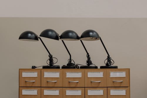 Black Headphones on Brown Wooden Cabinet