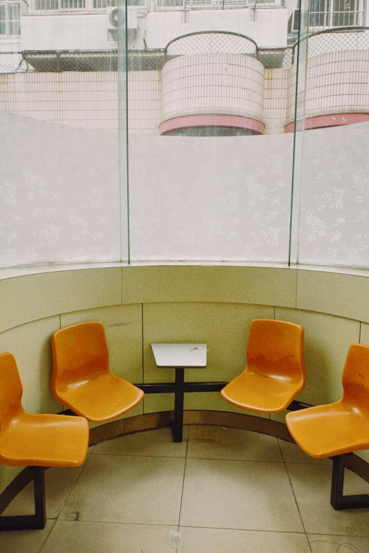 An Orange Public Chairs By The Frosted Glass Window