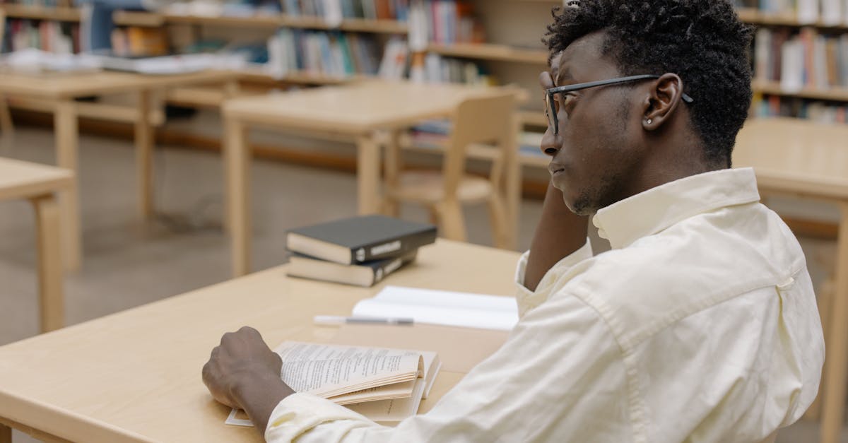 An open book with pages turning against a vibrant orange background, symbolizing knowledge and education.