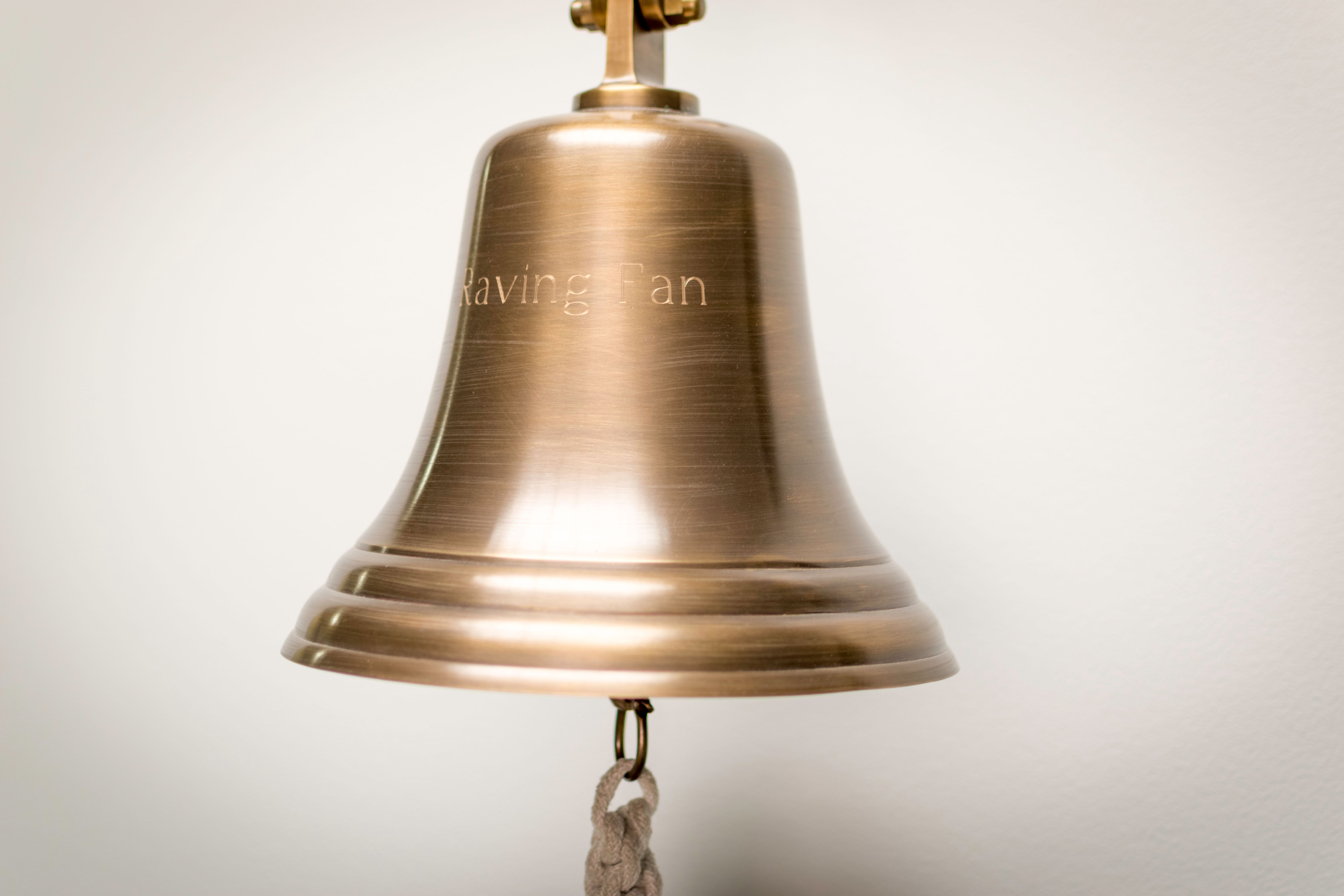 Gold-colored and Black Hanging Bells Near Wall \u00b7 Free Stock Photo