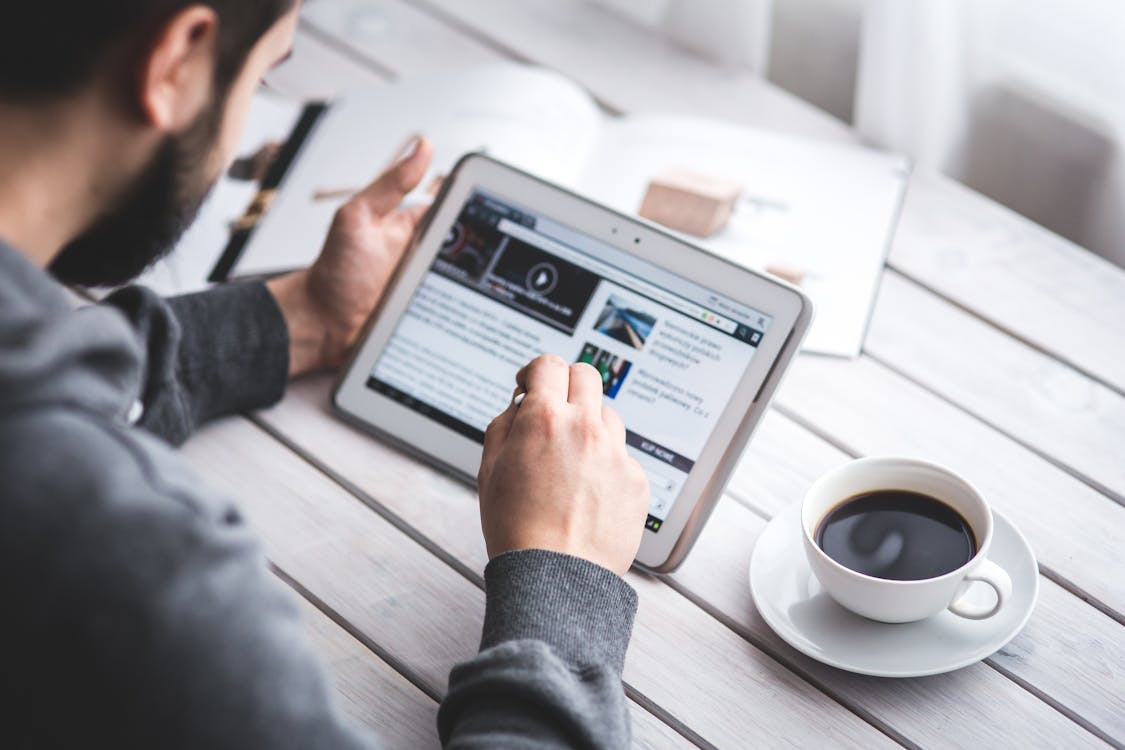 Free Man using stylus pen for touching the digital tablet screen Stock Photo