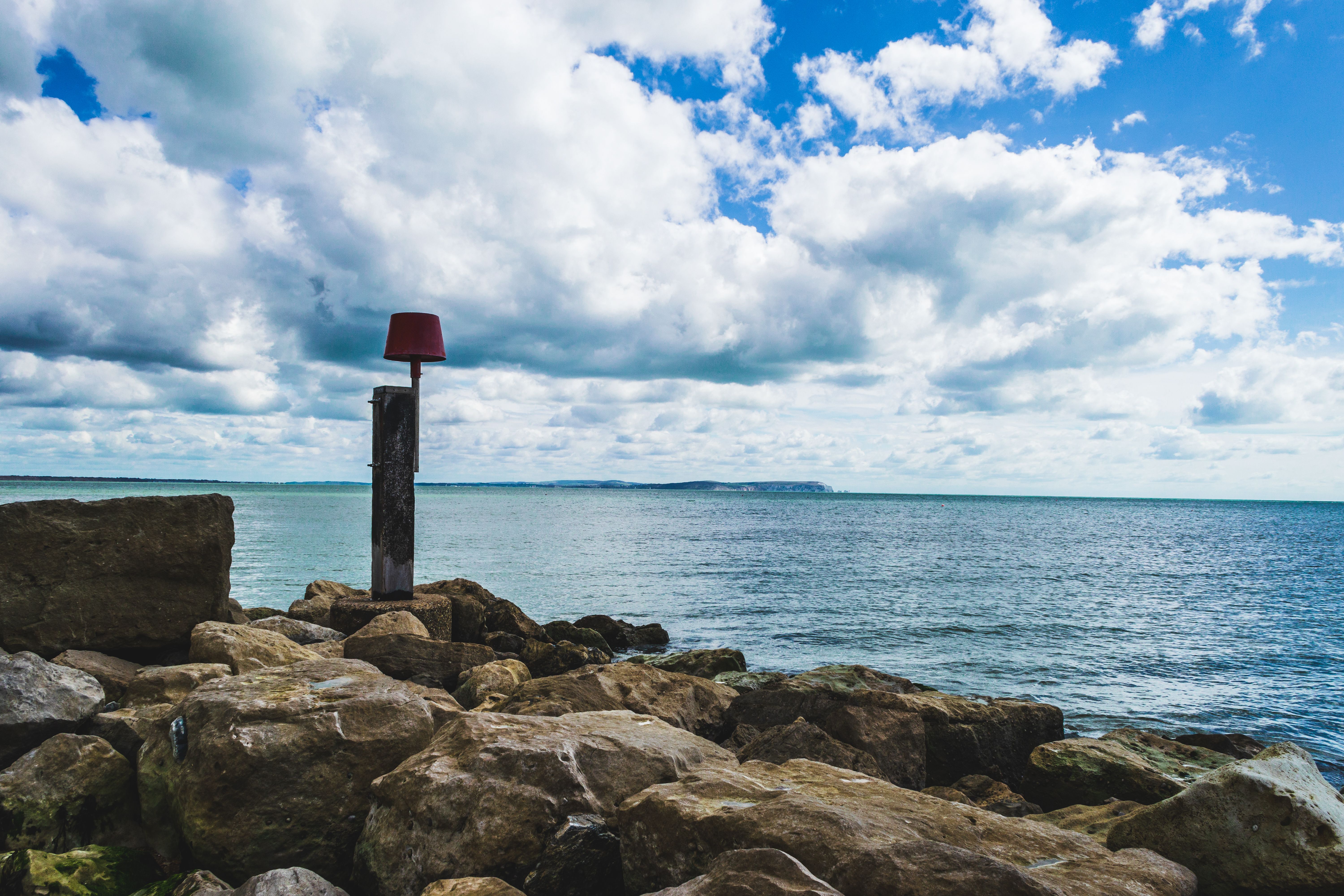 Scenic seafront view with rocks and ocean in Bournemouth, UK.