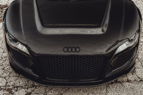 Free Detailed front view of a black Audi R8 supercar showcasing its carbon fiber hood and grille. Stock Photo