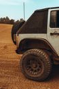 Muddy White Car Parked on Dirt Road