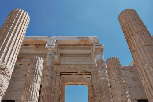Free Low angle view of ancient Greek columns under a clear blue sky in Athens. Stock Photo