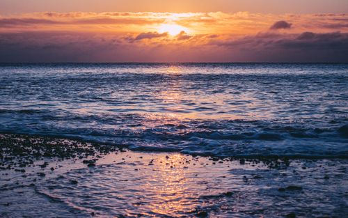 Free Experience the breathtaking sunrise over the sea at Bournemouth beach, England. Stock Photo