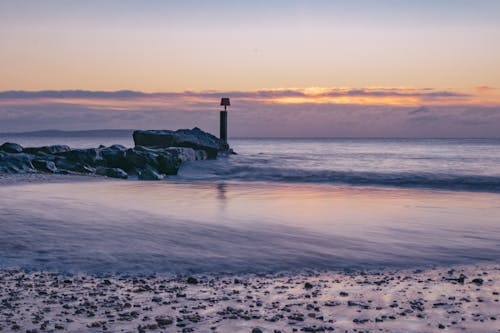 Sea Waves Crashing on Shore during Sunset