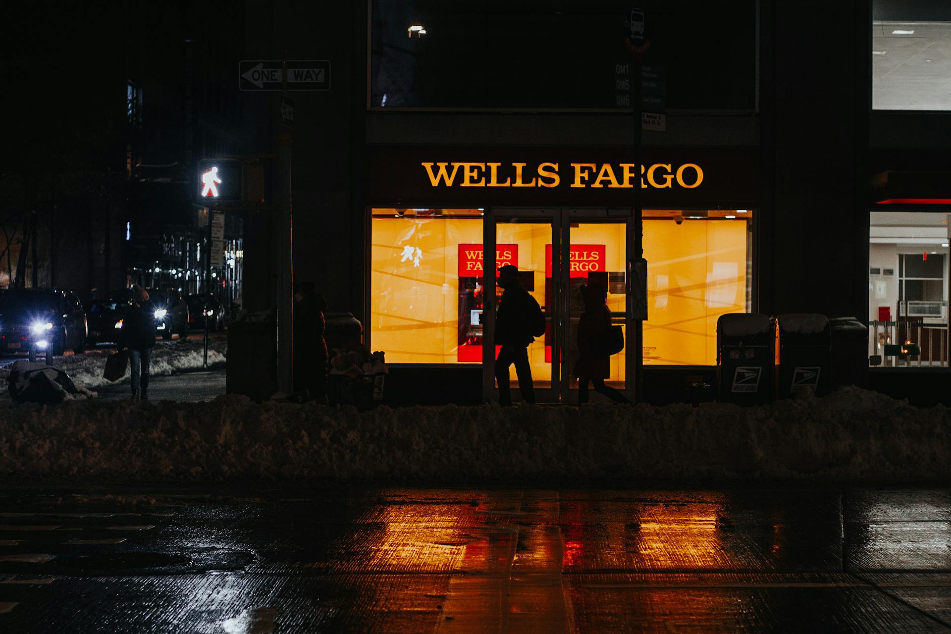 Busy contemporary New York City street with moving cars and walking pedestrians in winter evening