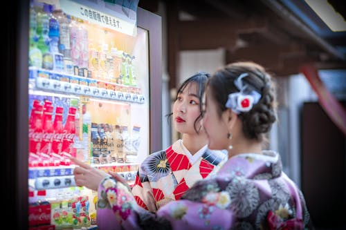 Women Buying from a Vending Machine