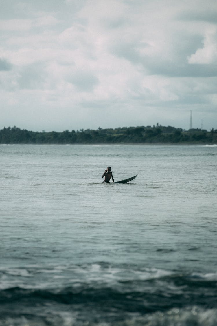 Person Surfing On The Sea