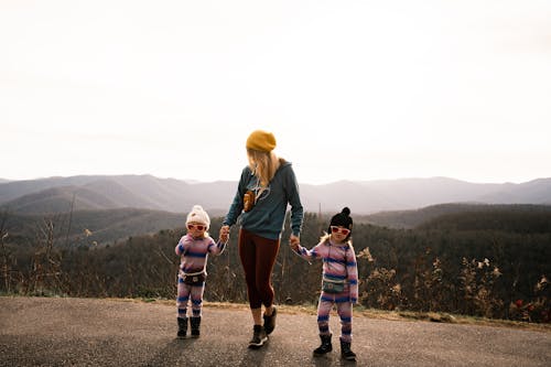 Mother and Daughters Posing In Front of Mountain Ranges