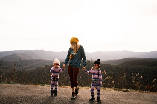 Mother and daughters enjoy a scenic mountain walk in Asheville, NC.