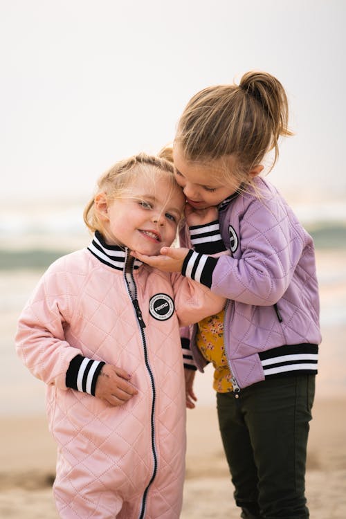 Free Girls Wearing Jackets Holding Each Others' Face Stock Photo
