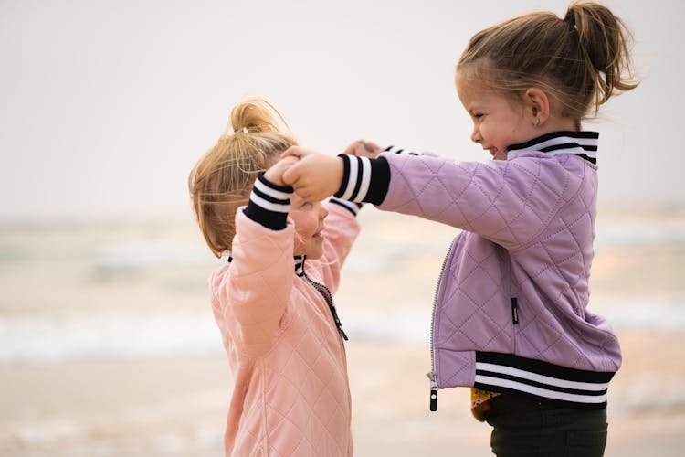 Girls Wearing Jackets  Dancing On The Beach