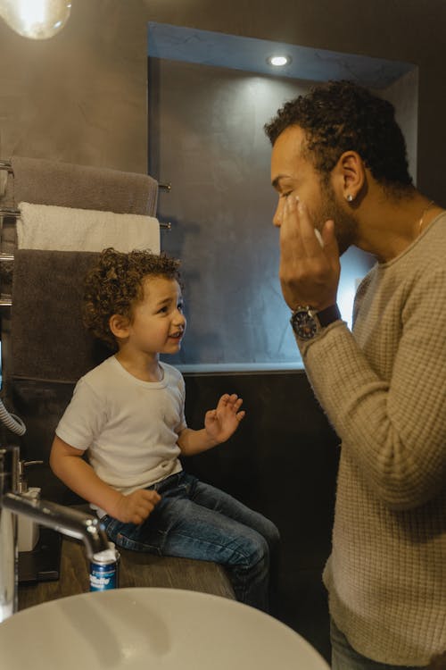 Father Putting Shaving Cream Showing His Son