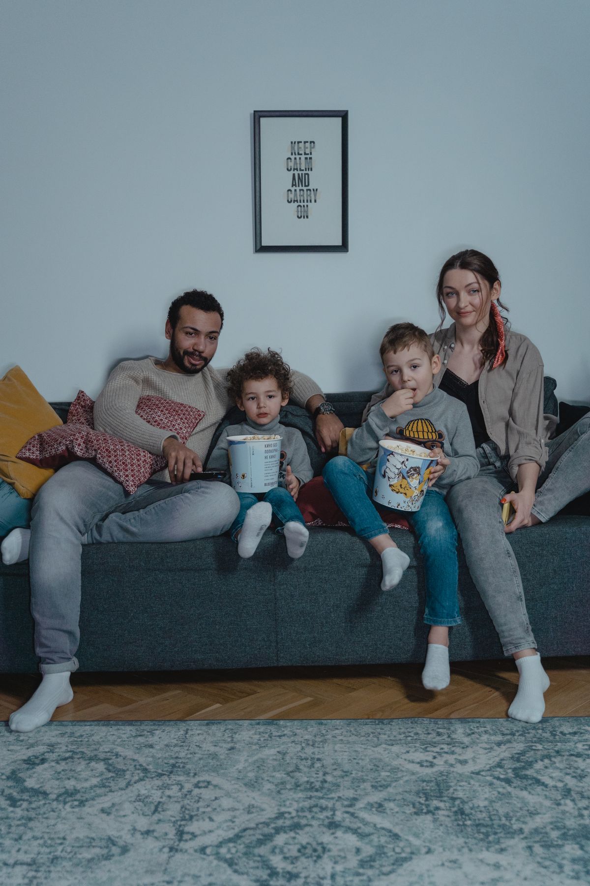 A family enjoying a cozy movie night with popcorn.