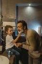 Boy Playing with Shaving Cream on a Man's Face