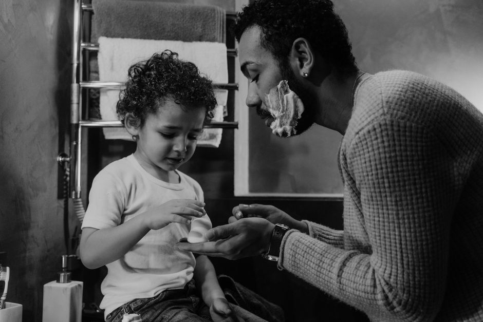 Photo by Tima Miroshnichenko on Pexels A touching black and white portrait of a father teaching his young son shaving in the bathroom. - Photo by Tima Miroshnichenko on Pexels