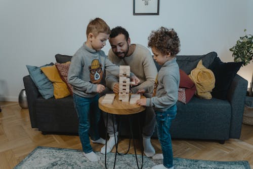 Free Kids Playing Wooden Blocks with their Father Stock Photo