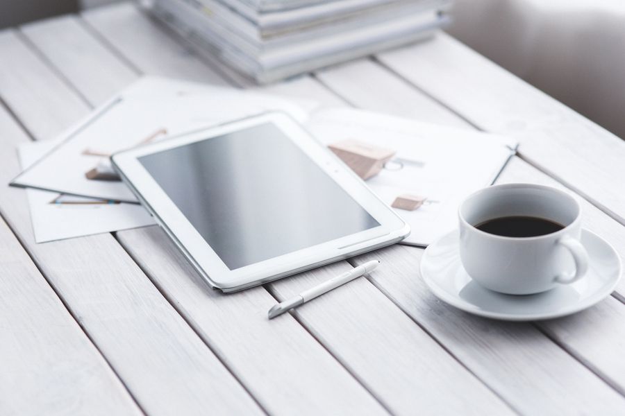 A tablet and notebook on a bright studio desk — photo by Karolina Grabowska on Pexels