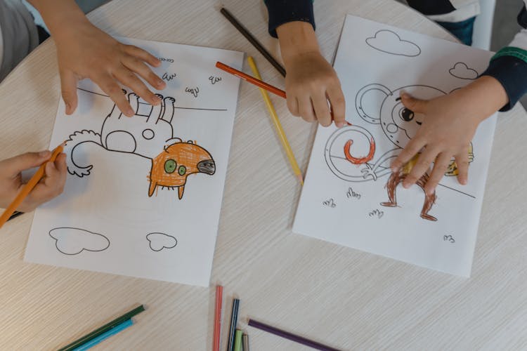 People Coloring The White Printer Paper With Drawing